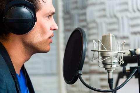 Man speaking with a pop filter